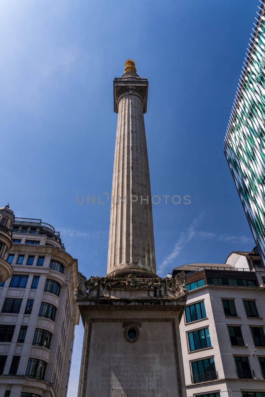 Modern architecture of offices surround the Monument to Great Fire of London