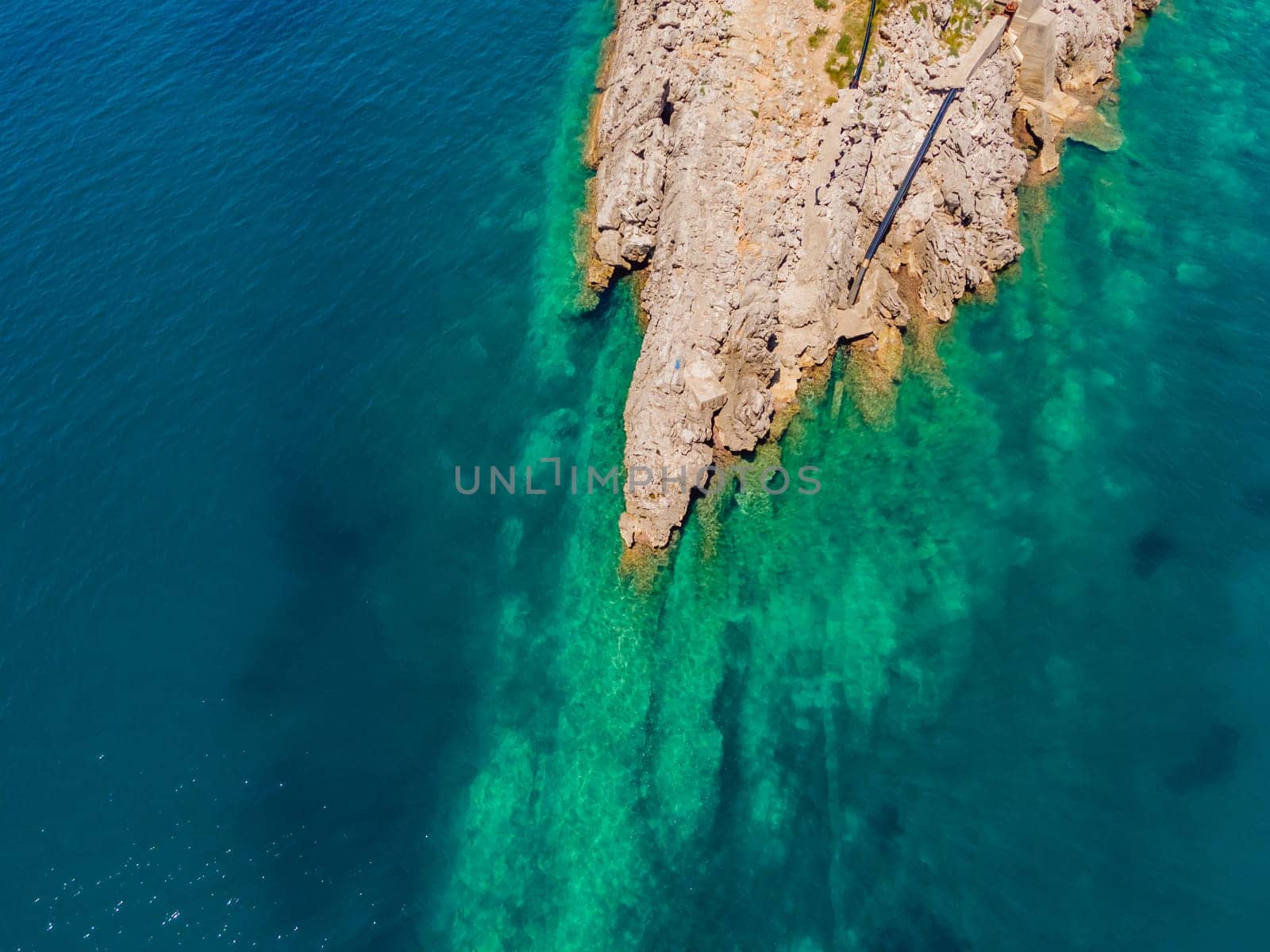 The pipe drains the sewer into the sea. Environmental pollution. Drone view.