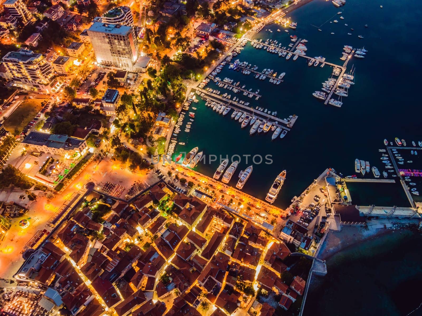 Budva city lights from Montenegro seen from above. Night view. Drone old town Budva at night.