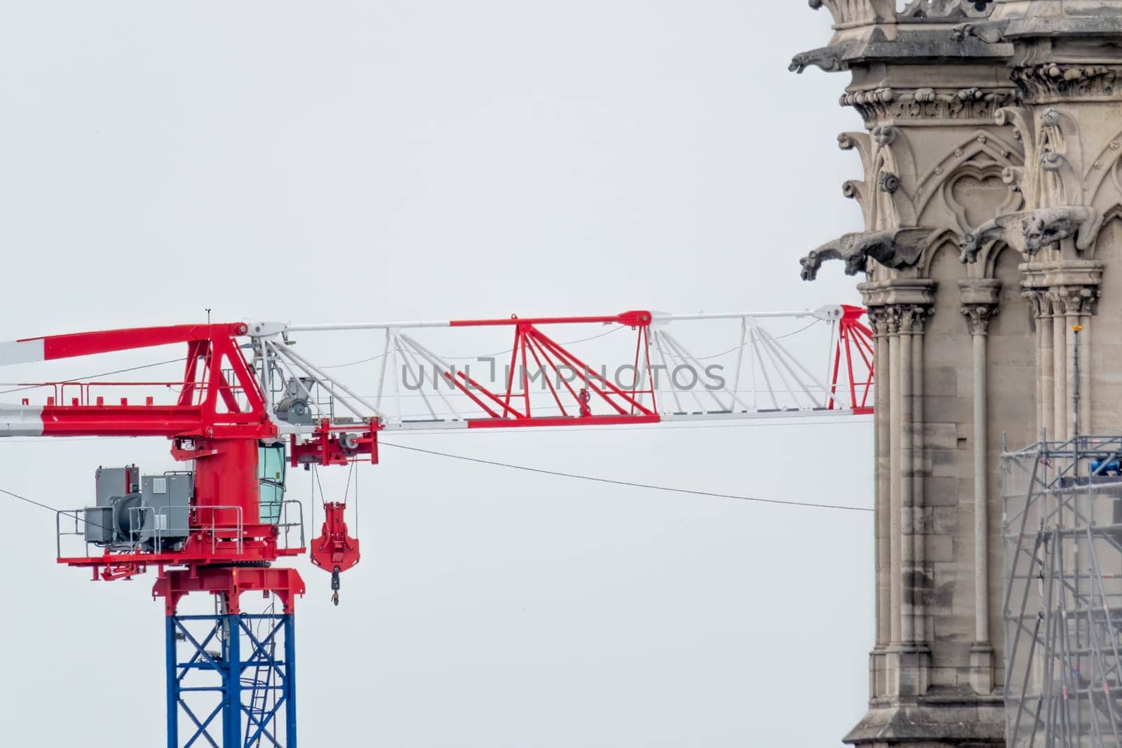 6 May 2023. Paris, France. Work continues on Notre Dame cathedral in preparation for the 2024 Olympics games. A construction crane is seen behind a tower with gargoyles at Notre Dame cathedral after the tragic fire in 2019