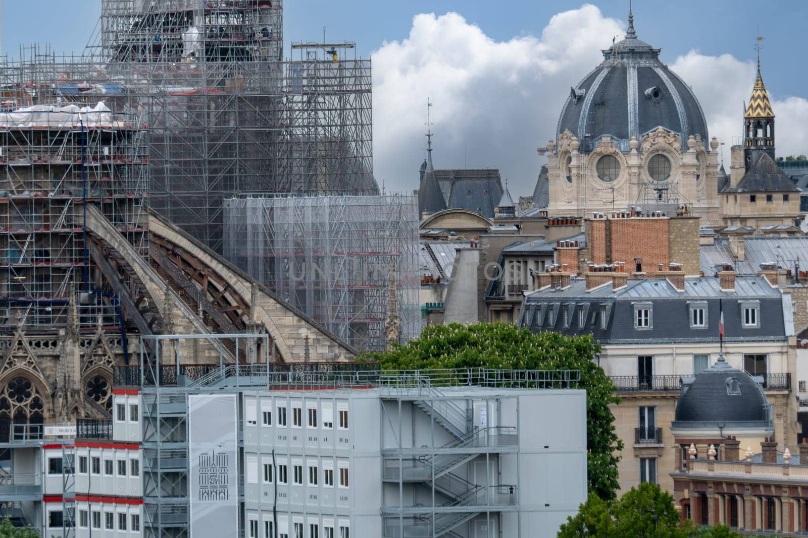 6 May 2023. Paris, France. Restoration and repair work continues in the city of Paris in preparation for the 2024 Olympics. Many famous landmarks are visible in the distance. Selective focus