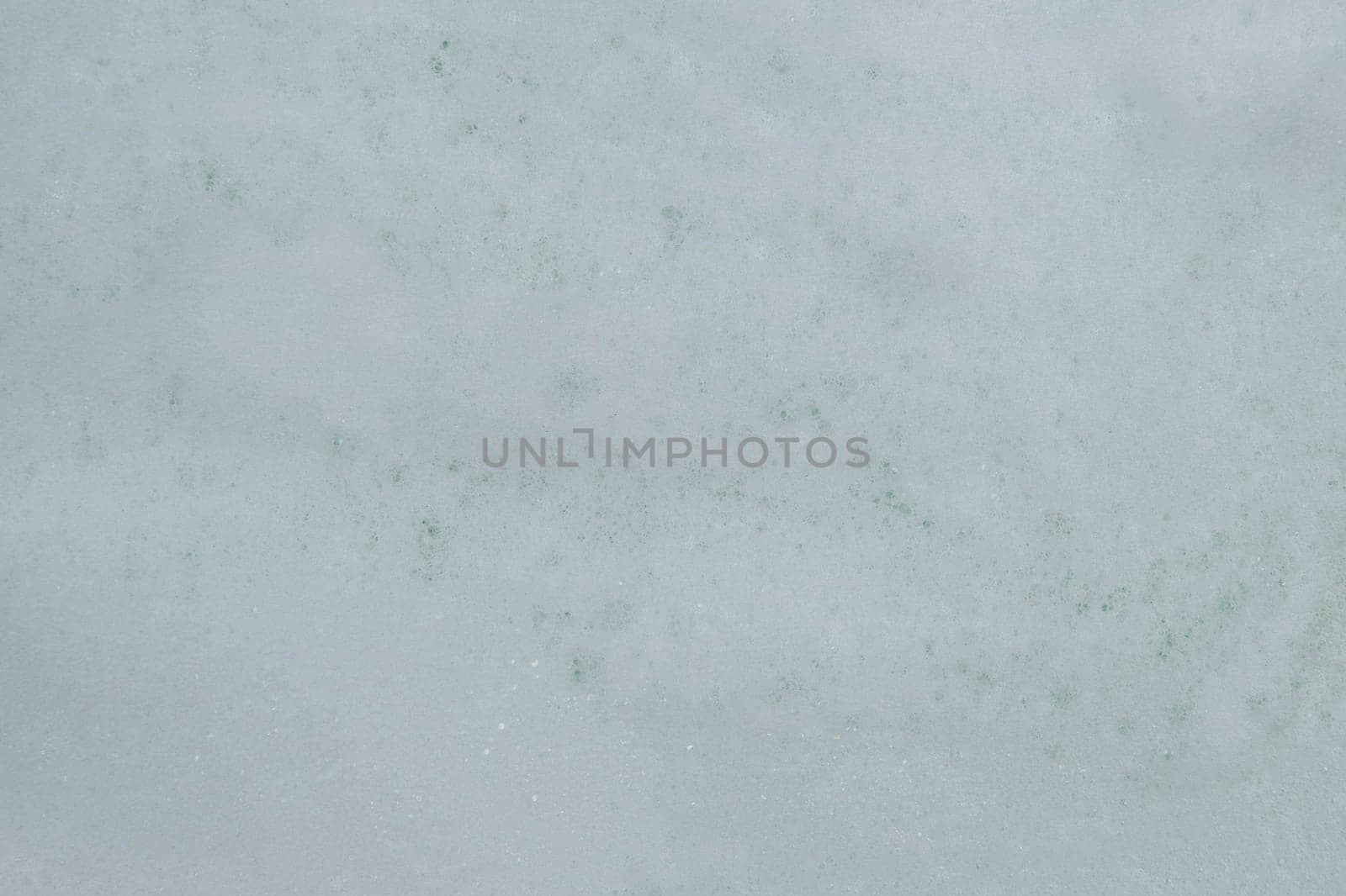 Texture of white soap foam with abstract soap bubbles background.