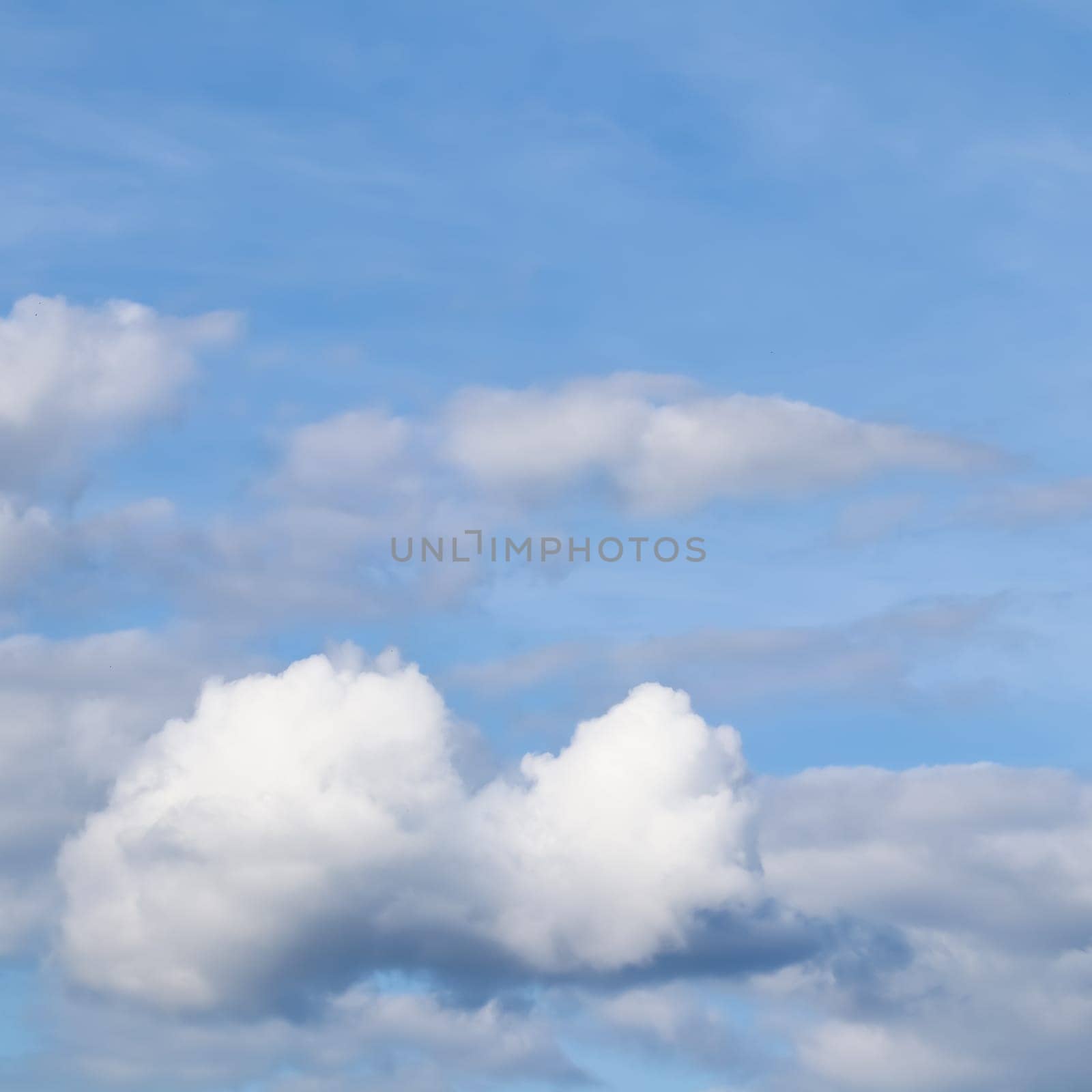 Background of blue sky with white clouds. Natural backdrop