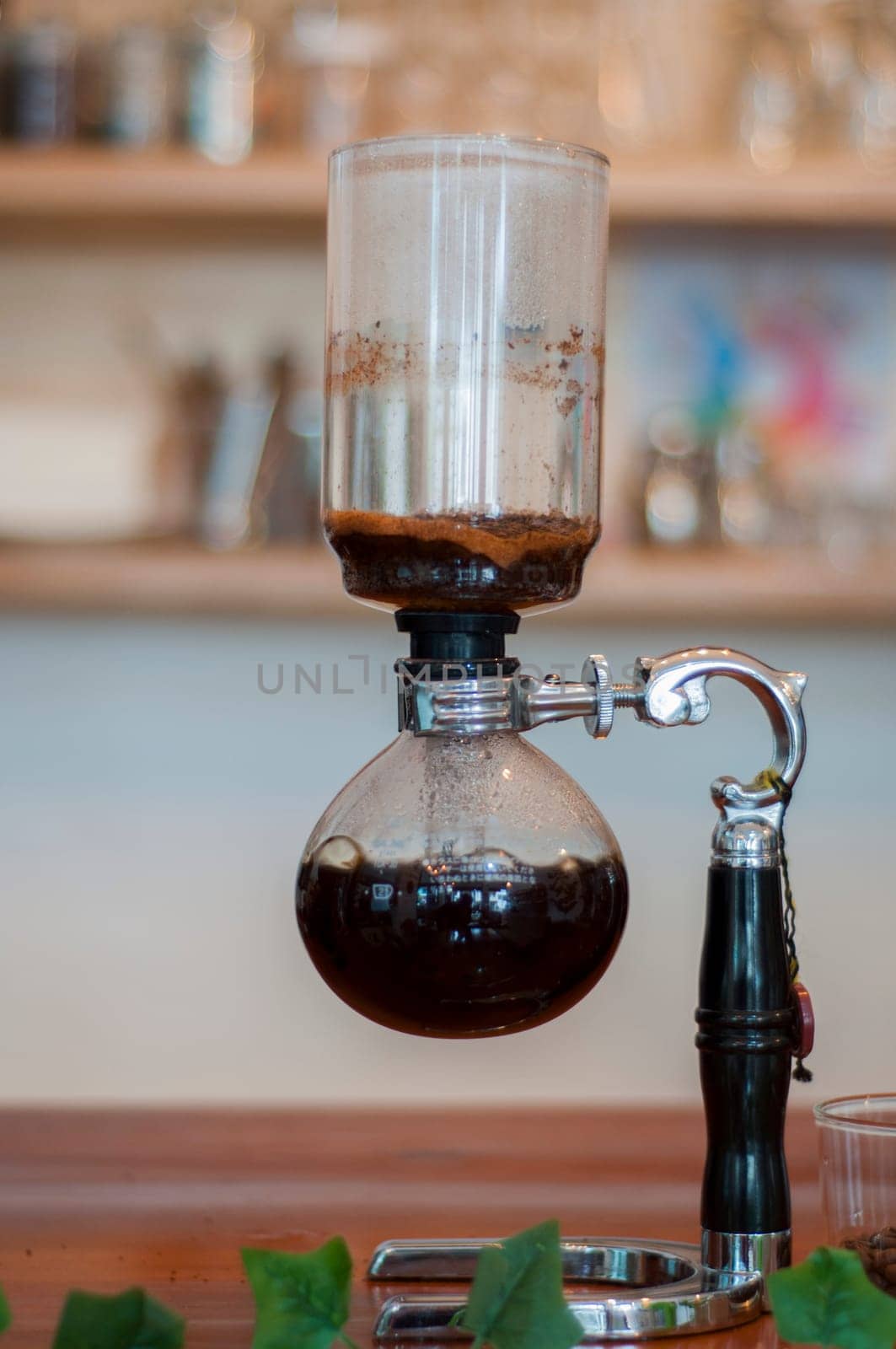 Siphon coffee maker on a bar in a cafeteria giving off hot coffee. High quality photo