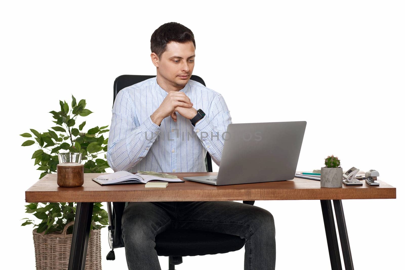 calm man using laptop computer for online work at table on white background