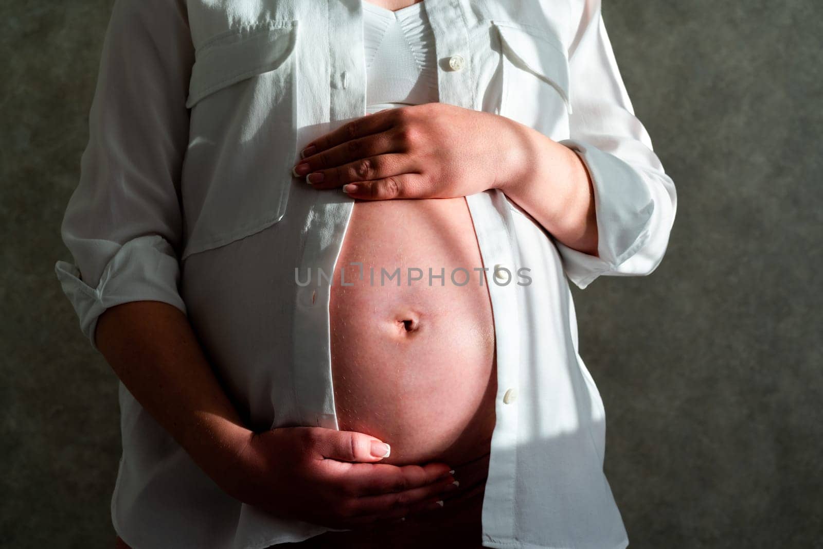 Pregnant woman belly. Pregnancy concept. Mid-section portrait of unrecognizable woman during last months of pregnancy