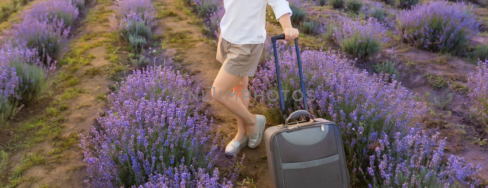 woman with luggage in lavender field by Andelov13