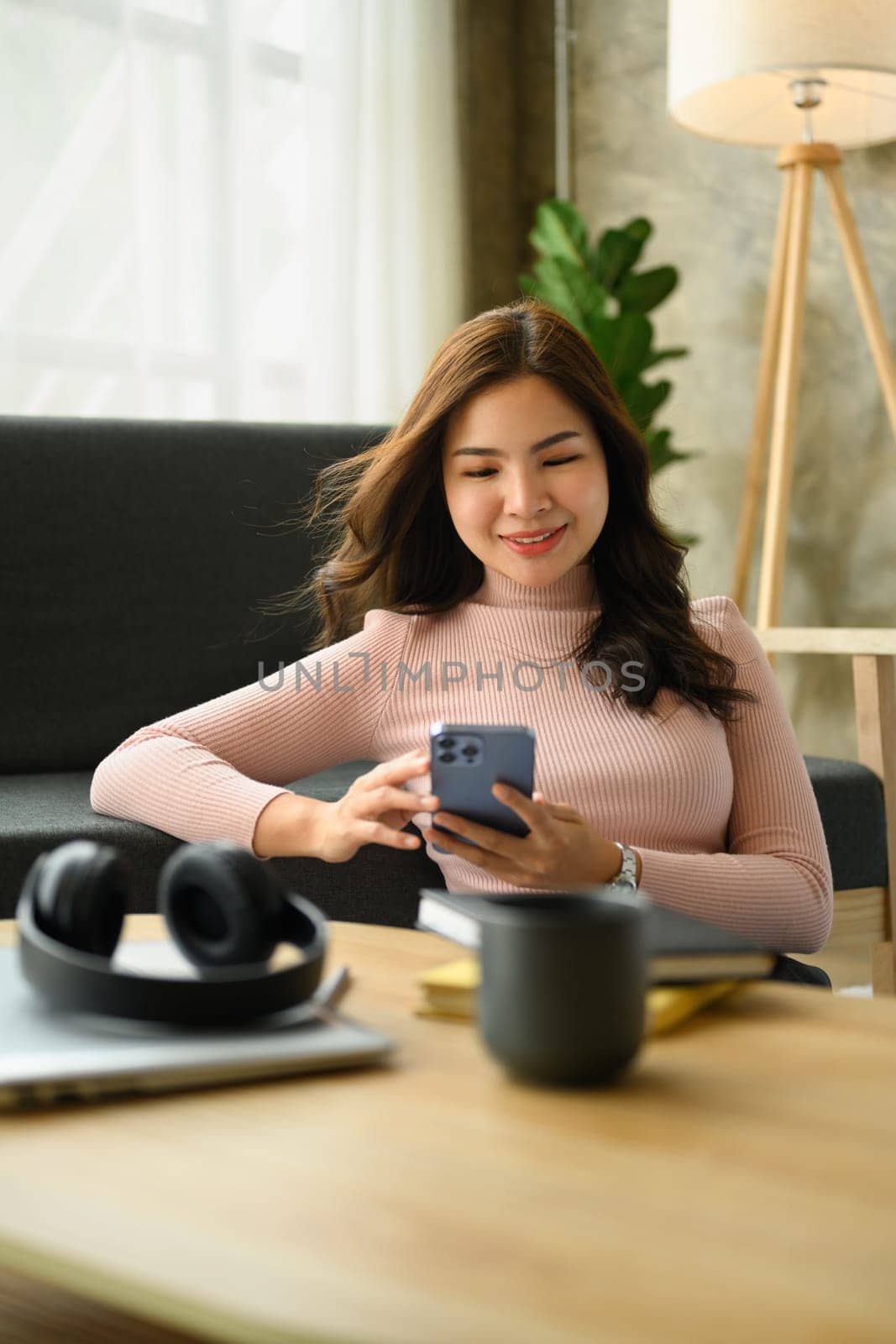 Beautiful young woman using smartphone, texting messaging, communication in social media.