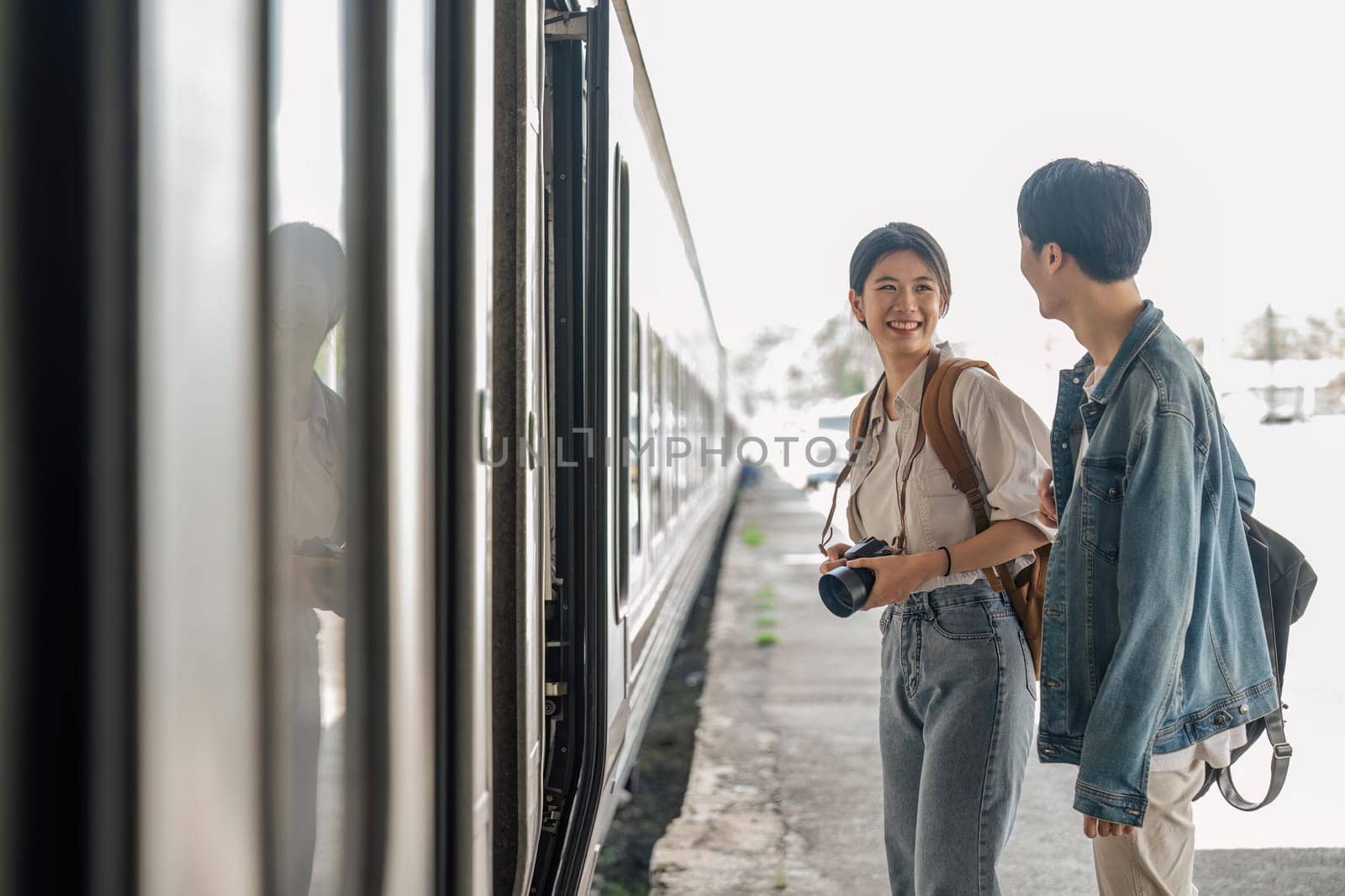 Couple at railway station take the train for the travel on holiday.