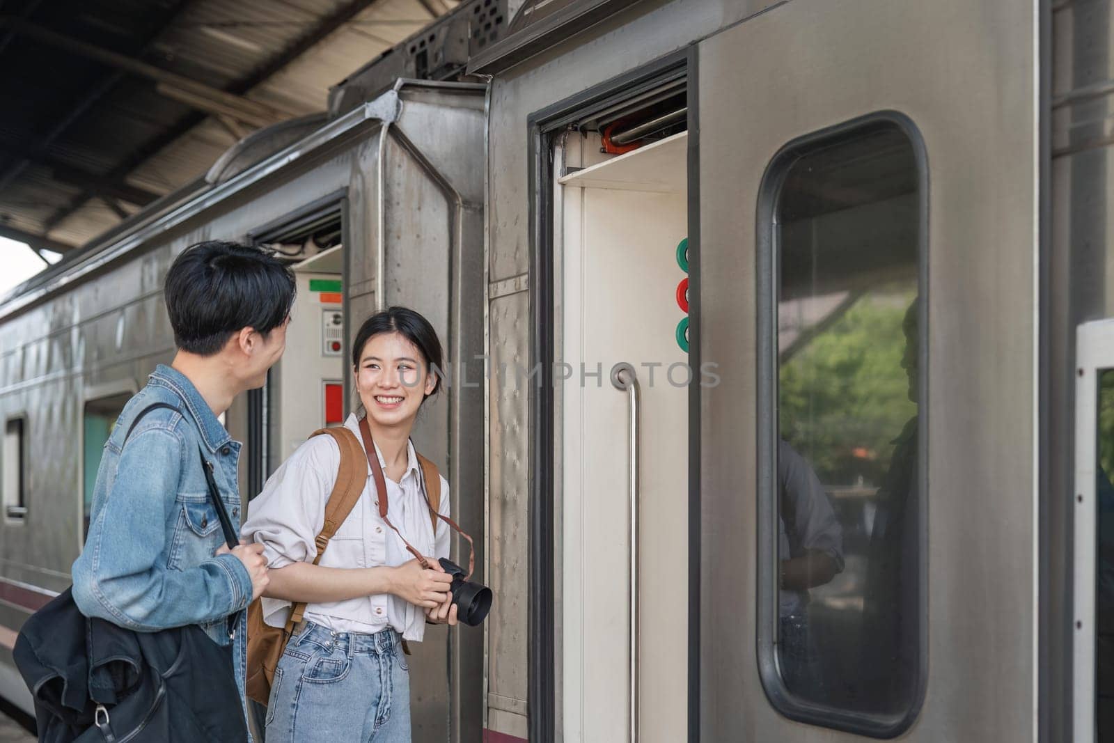 Couple at railway station take the train for the travel on holiday.