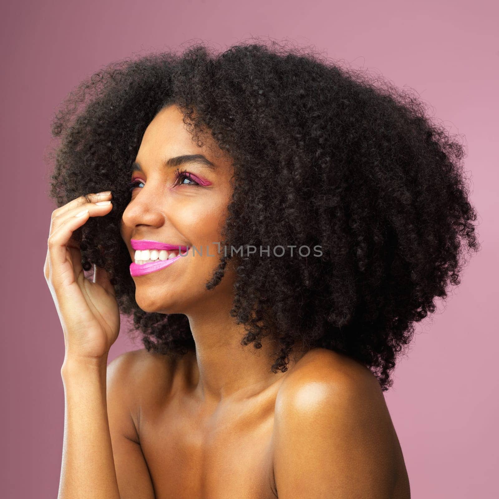 No beauty shines brighter than happiness. Studio shot of an attractive young woman posing against a pink background. by YuriArcurs