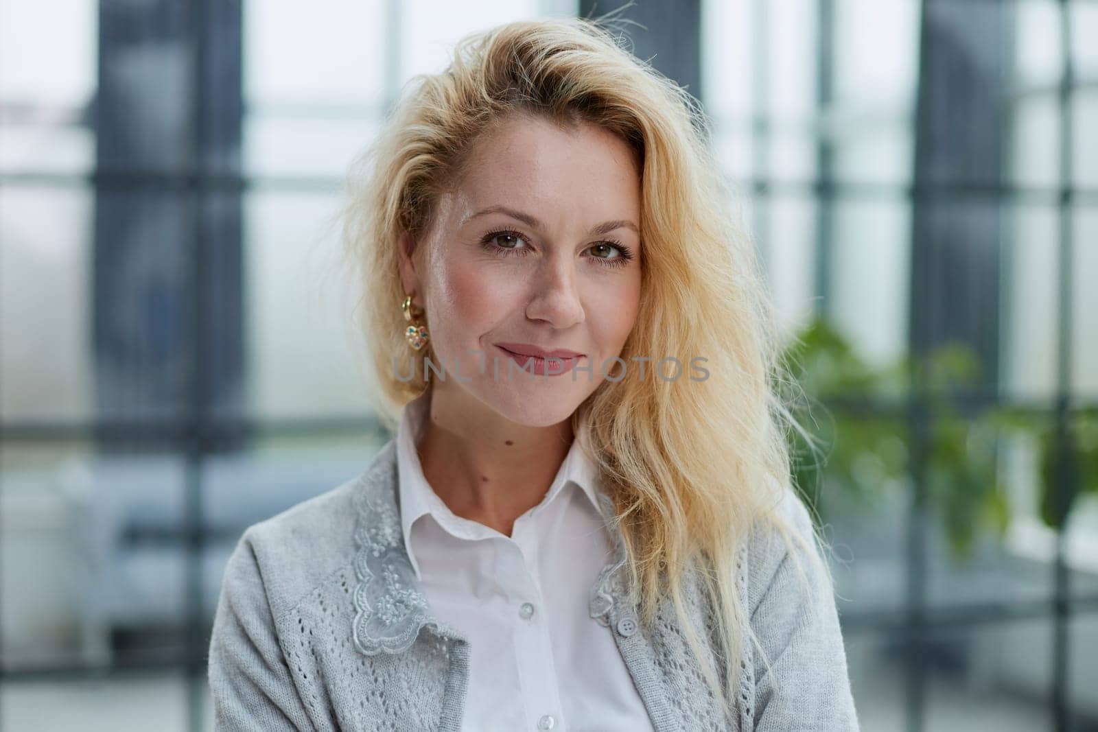 Attractive woman looking pensively at the camera in office