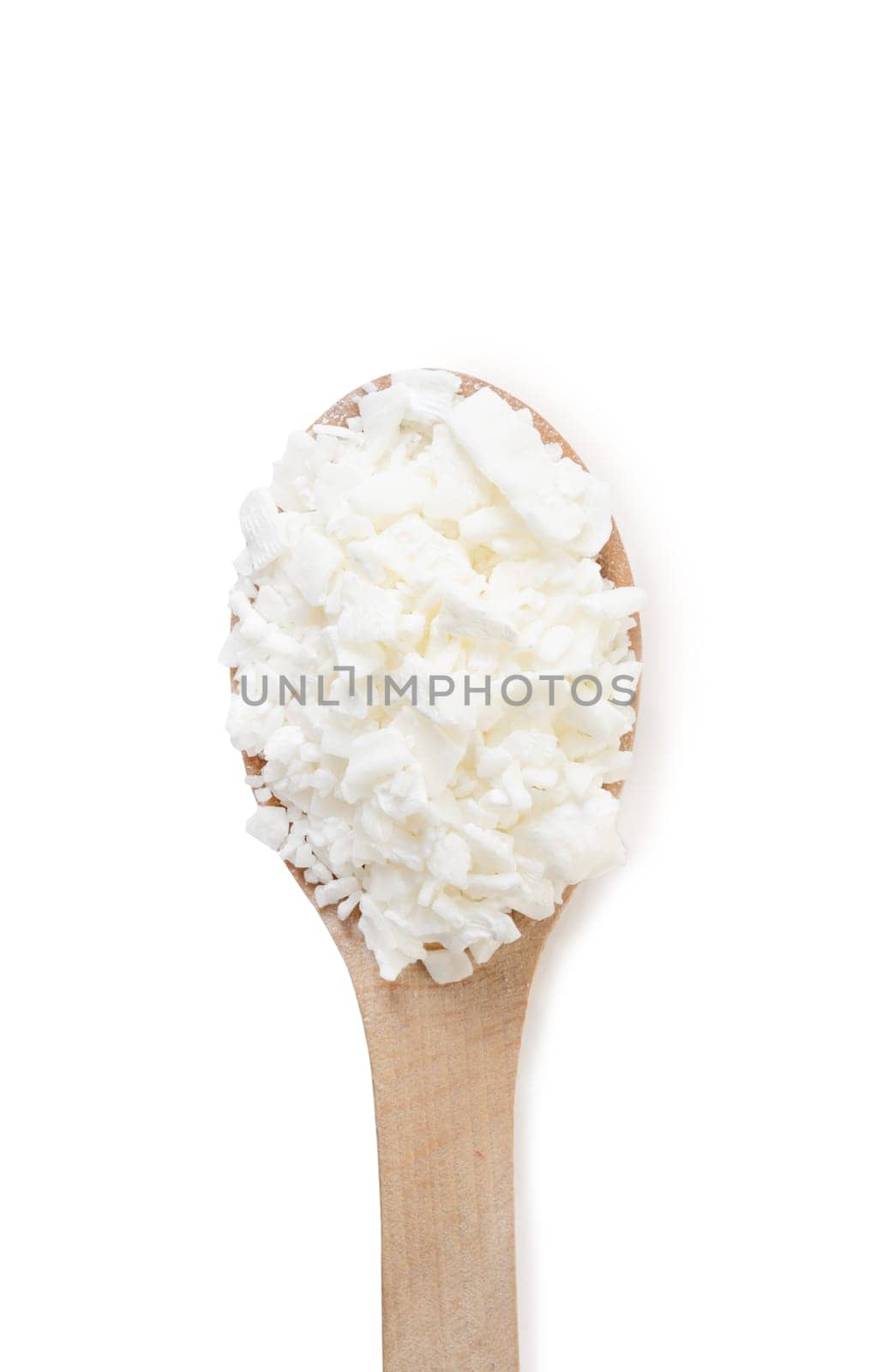 Organic white soy wax flakes for candles in small measure spoon isolated on white background by Desperada