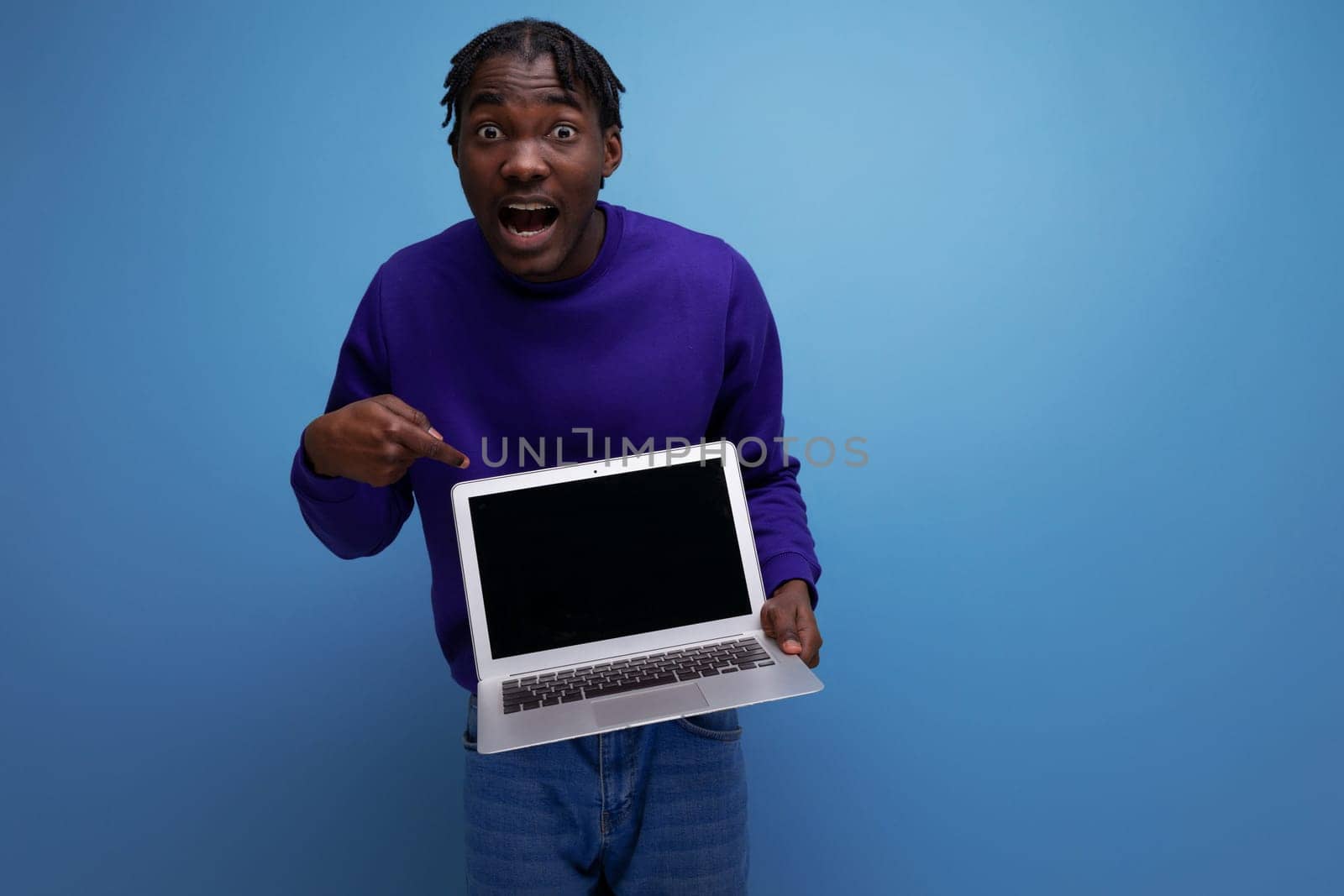 freelancer african young brunette man with dreadlocks with laptop by TRMK
