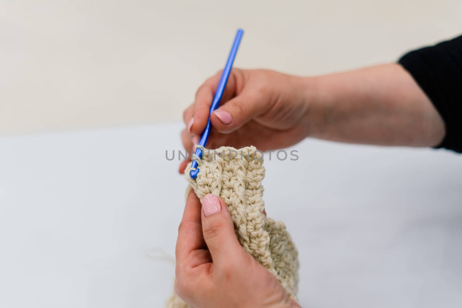 Process of a knitting isolated on white, female hands