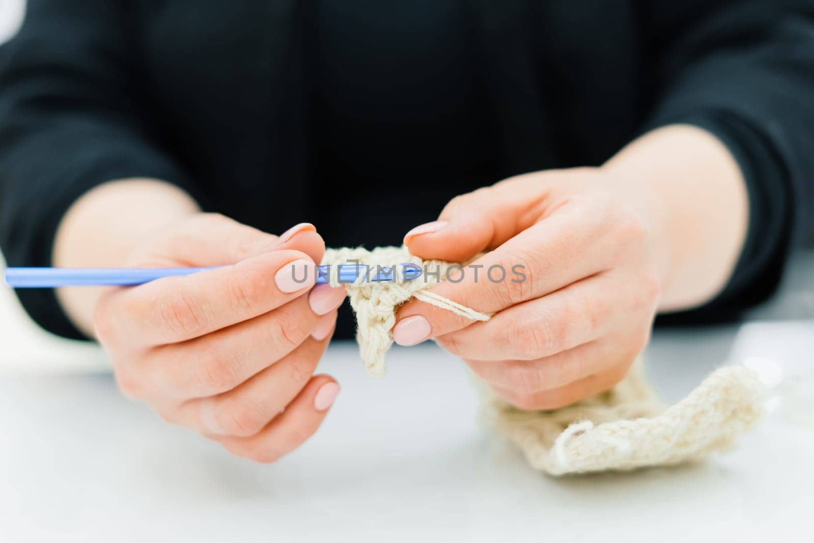 Process of knitting isolated on white, female hands by Zelenin