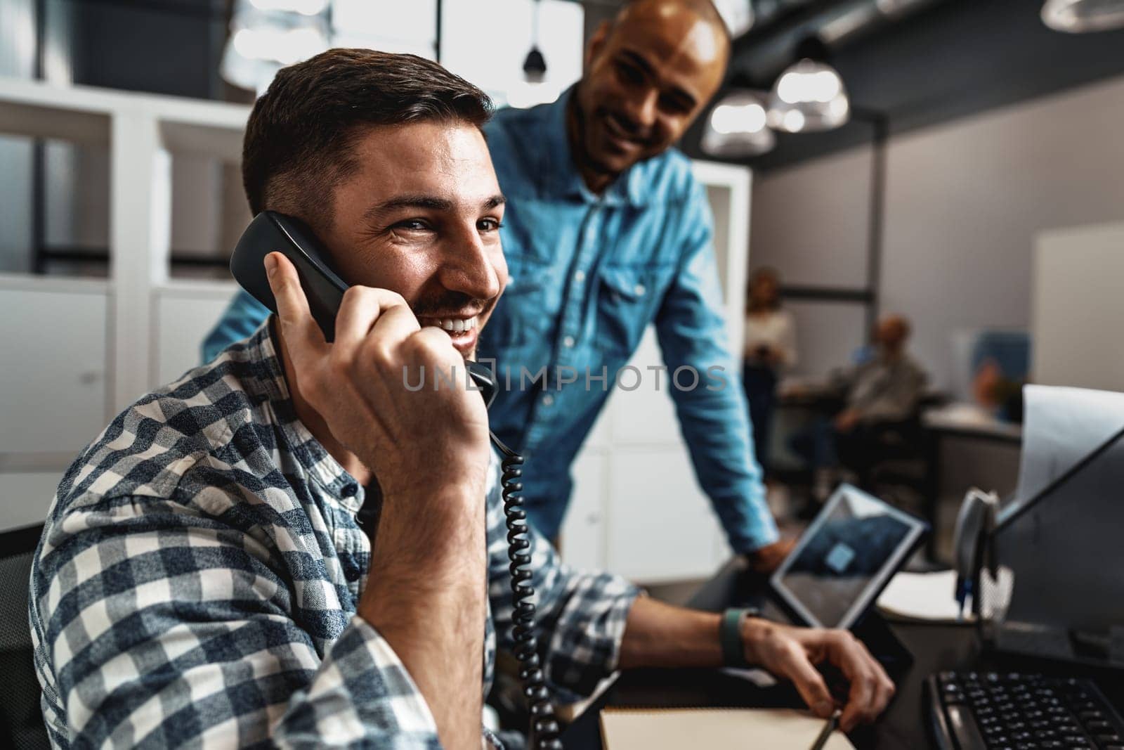 Two young men working together on a new business project in office, close up