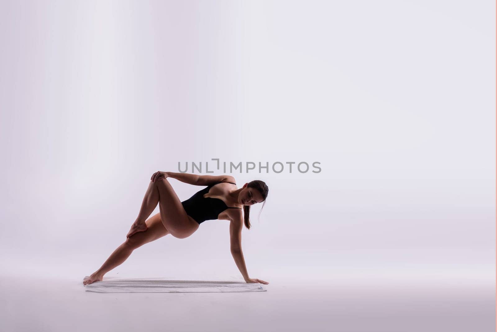 Beautiful woman doing poses on a yoga class. Studio shot.