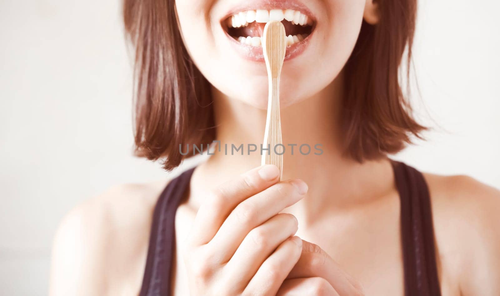 A young girl flosses her teeth, a woman takes good care of her snow-white smile, the health of her gums and tooth enamel.