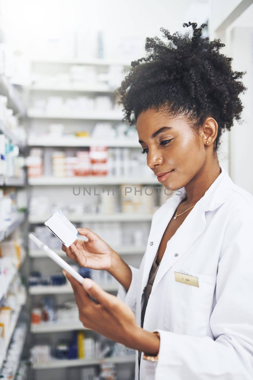 Theres nothing technology cant do these days. a pharmacist using a digital tablet in a chemist. by YuriArcurs