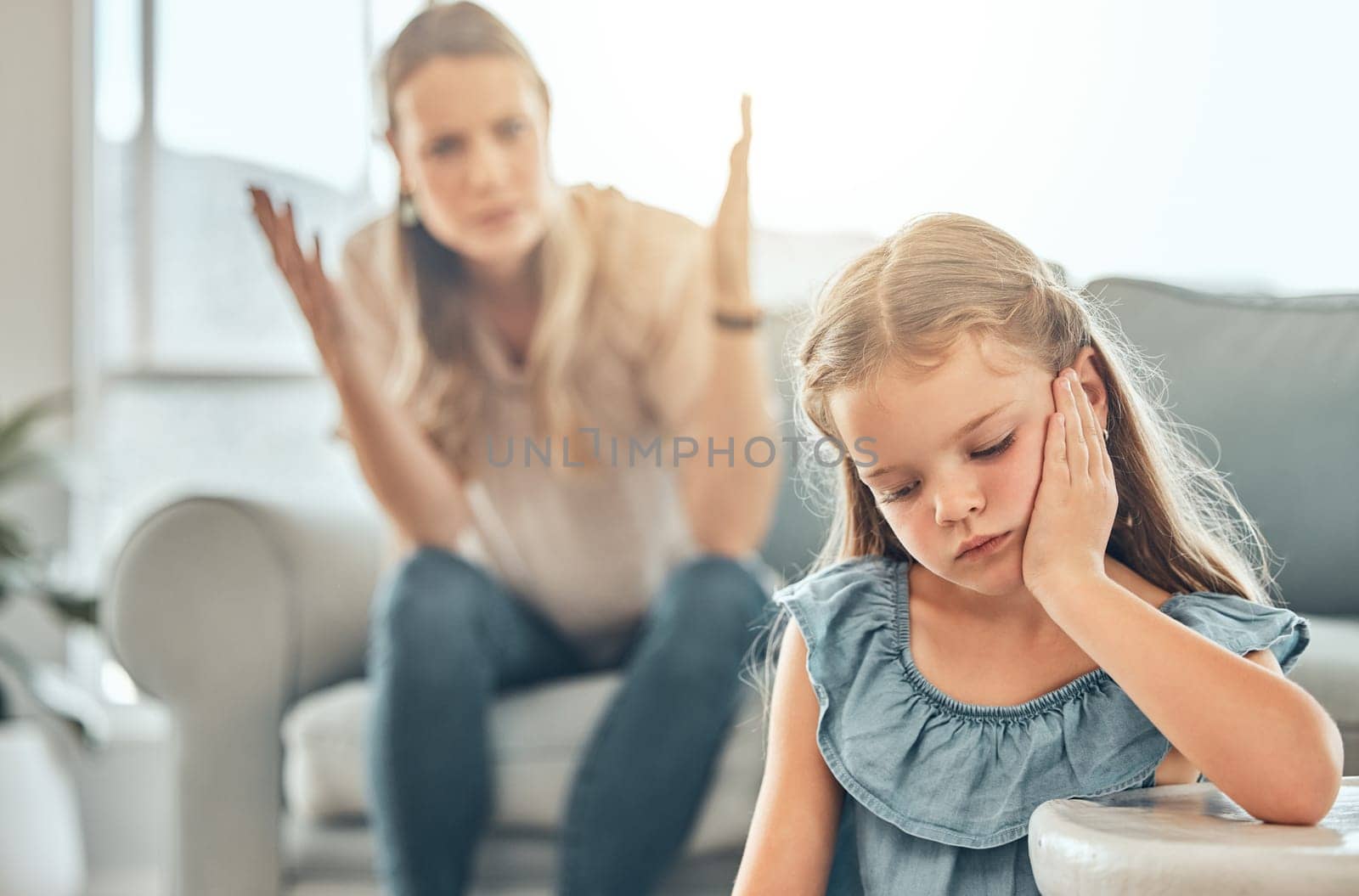 Angry lecture from mother, sad child and problem with discipline in living room, naughty girl behavior in home. Scolding, punishment and frustrated woman, stubborn kid and communication with anger