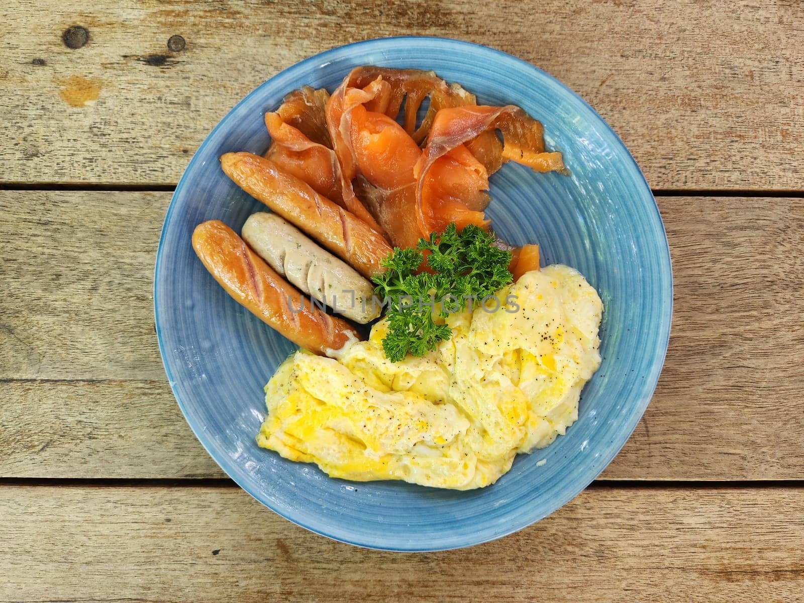 American breakfast top view on wooden table background. by kaisorn