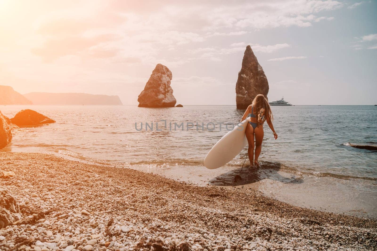 Woman sea sup. Close up portrait of happy young caucasian woman with long hair looking at camera and smiling. Cute woman portrait in bikini posing on sup board in the sea by panophotograph