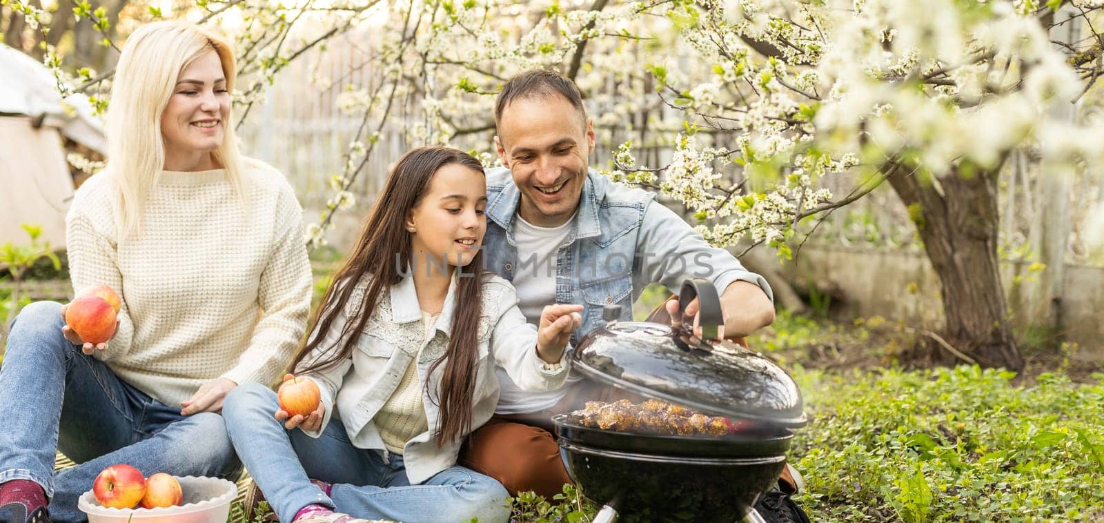 Family having a barbecue in their garden.