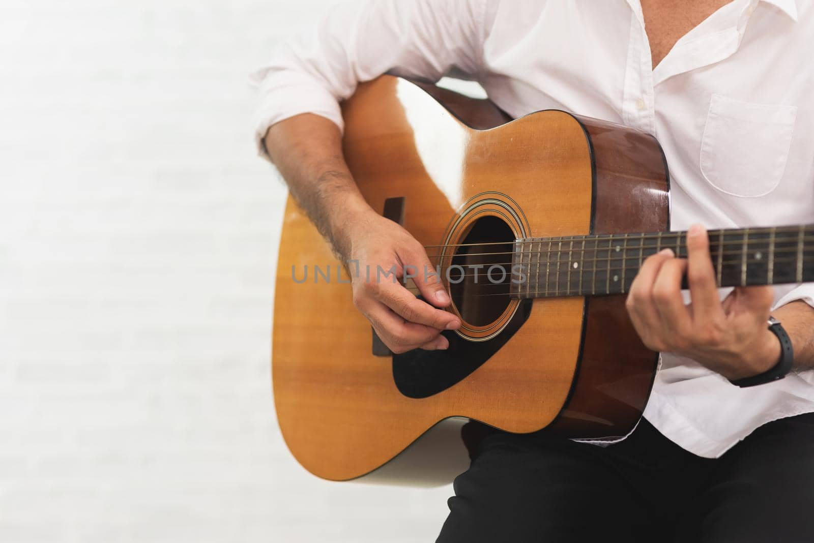man playing acoustic guitar on white background
