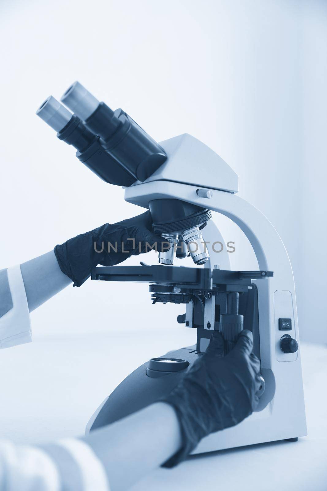 medical laboratory, scientist hands using microscope for chemistry, biology test samples, examining liquid, Doctor equipment, Scientific and healthcare research background. blue color. by Mariakray