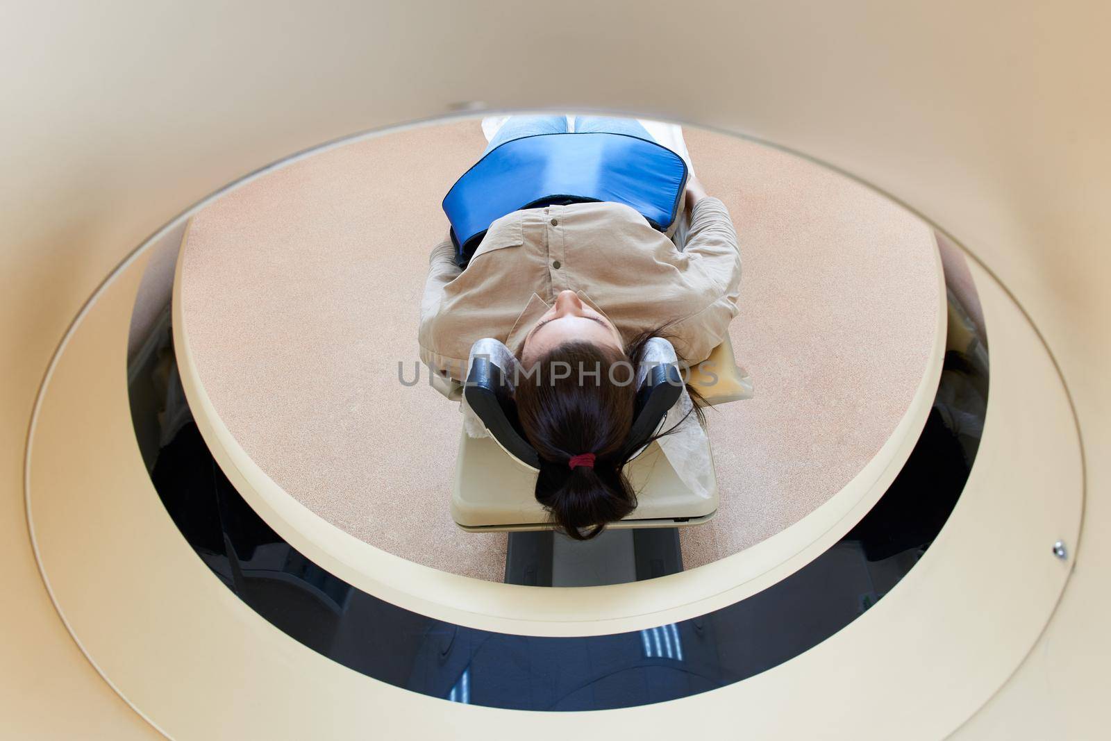 Female patient undergoing MRI - Magnetic resonance imaging in a Hospital. Medical Equipment and Health Care