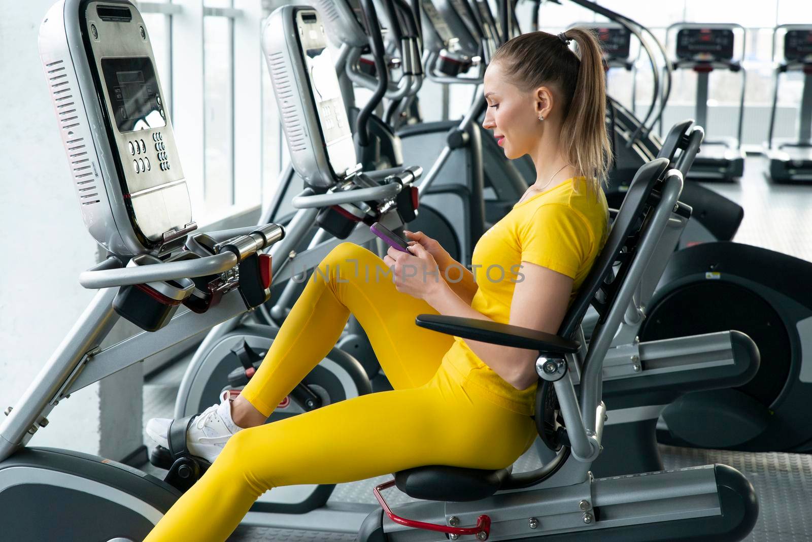 Woman riding an exercise bike in gym