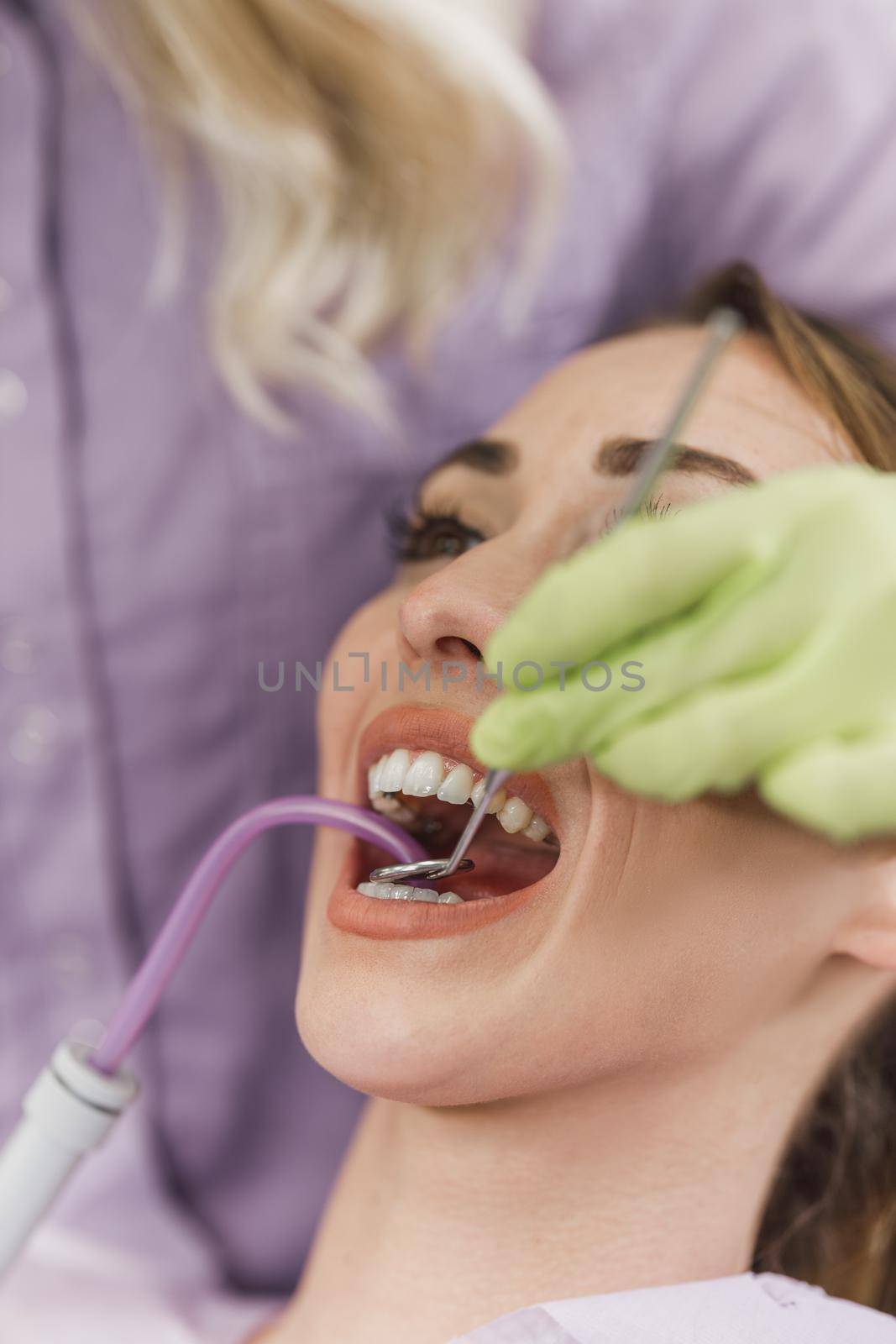 Close-up of a young woman having dental work done on her teeth.