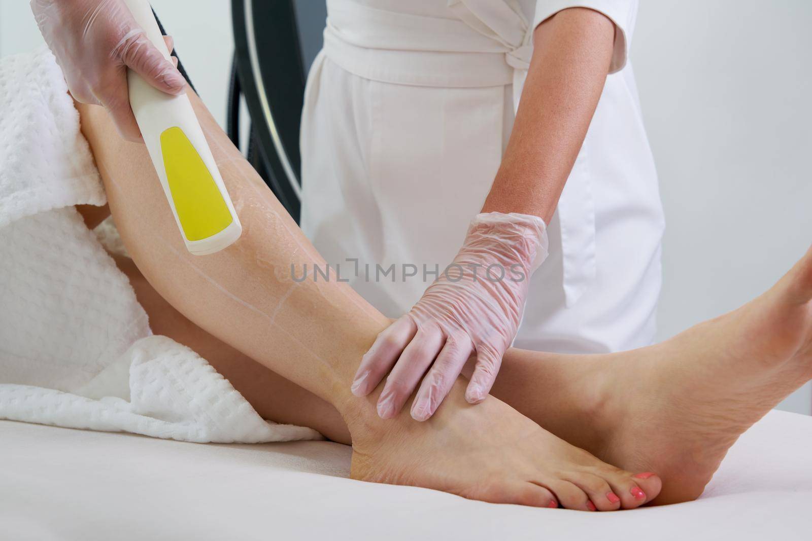 Female legs, woman in professional beauty clinic during laser hair removal