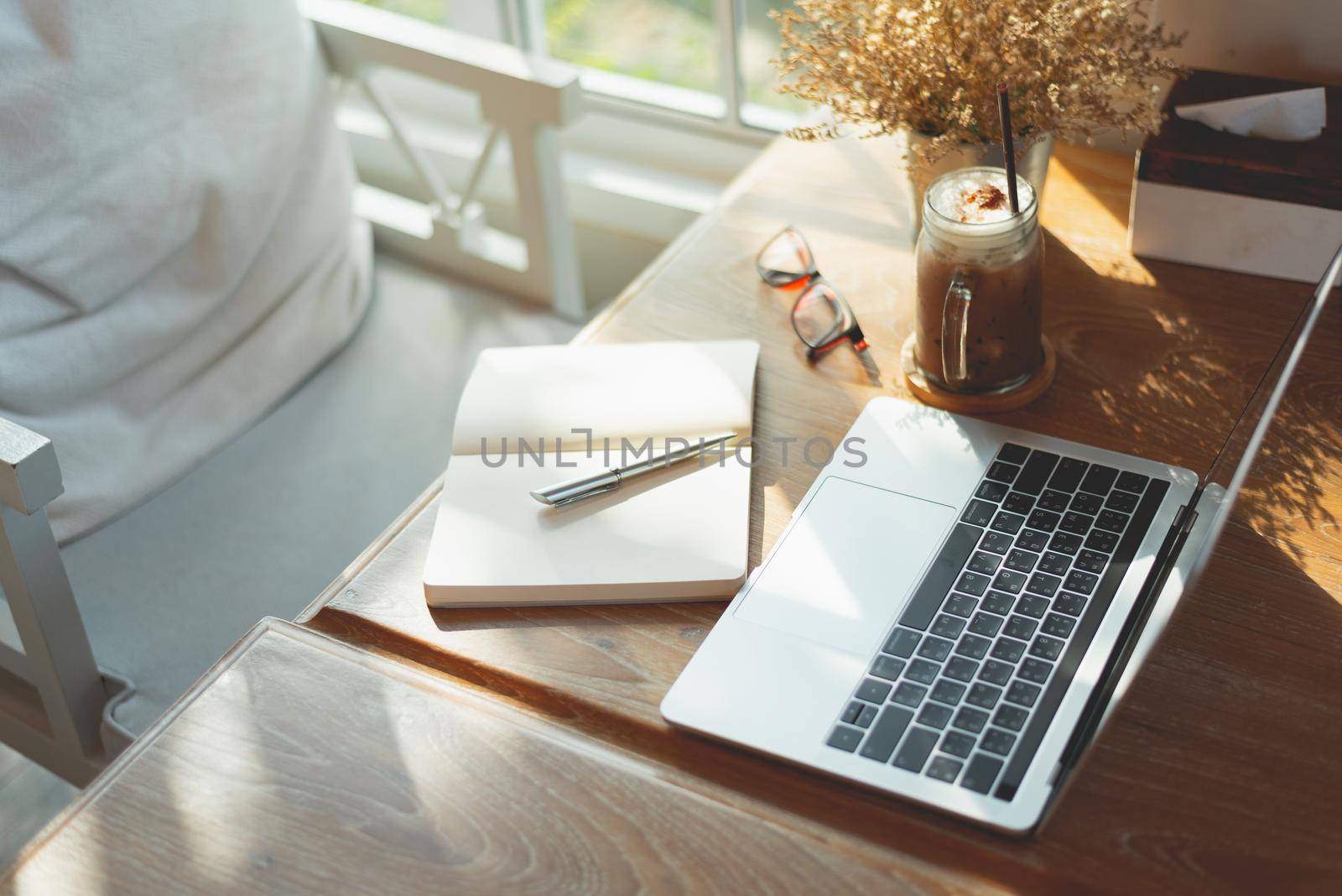 work space, laptop and note book on the table in the cafe, copy space business concept  by Wmpix