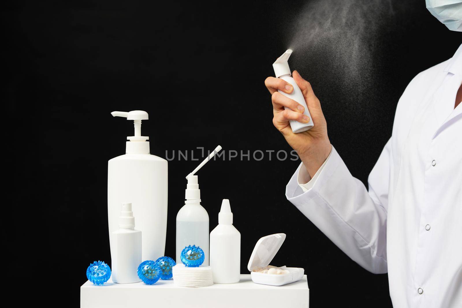 hand using sanitizer spray bottle against coronavirus.
