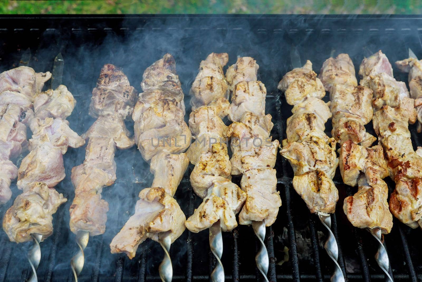 Process of frying meat on charcoal in the skewer are fried a classic barbecue by ungvar