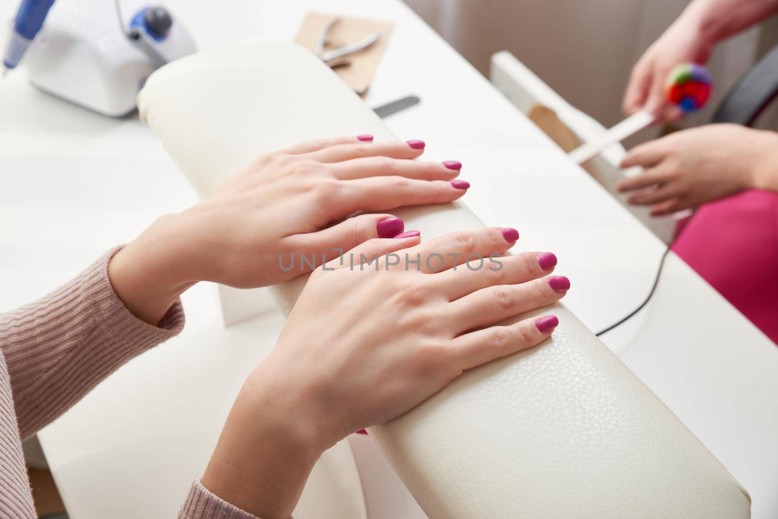 Young woman getting beautiful manicure in salon