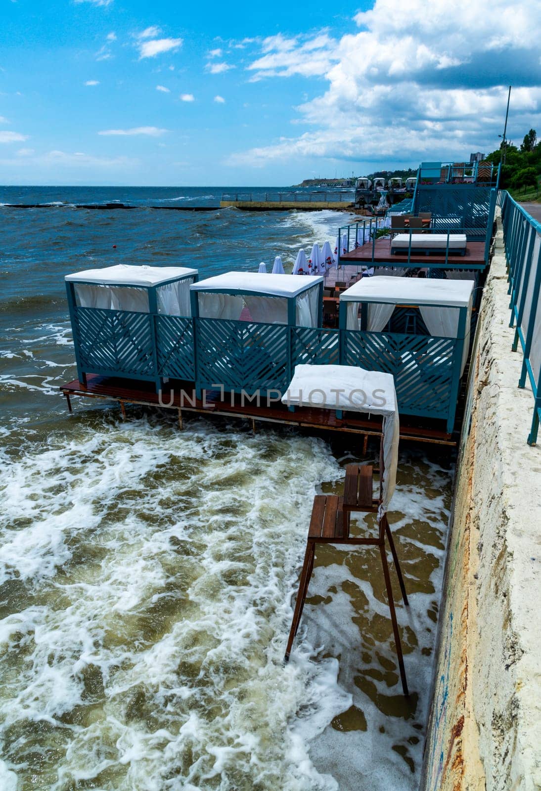 ODESSA, UKRAINE - JUNE 12, 2023: empty places to rest on a washed-out beach after the explosion of the Kakhovskaya hydroelectric power station in Odessa 