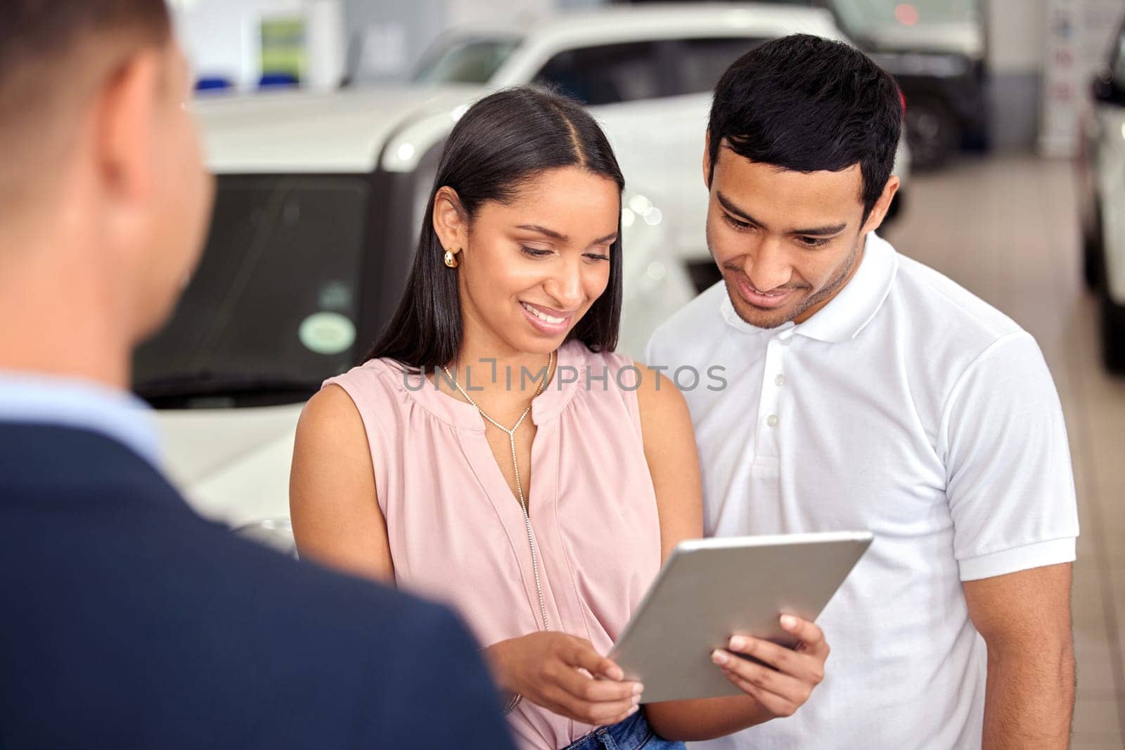 Tablet, car and shopping with couple and salesman for vehicle showroom, test drive and consulting. Auto, transportation and purchase with man and woman in dealership for insurance, sale and motor.
