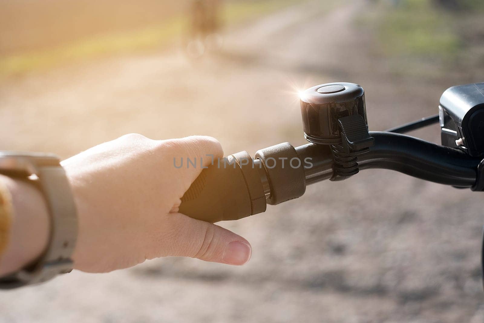 Close up hand holding onto the bicycle steering wheel. Both hands seen, prepairing to start cycling outdoors by Annavish