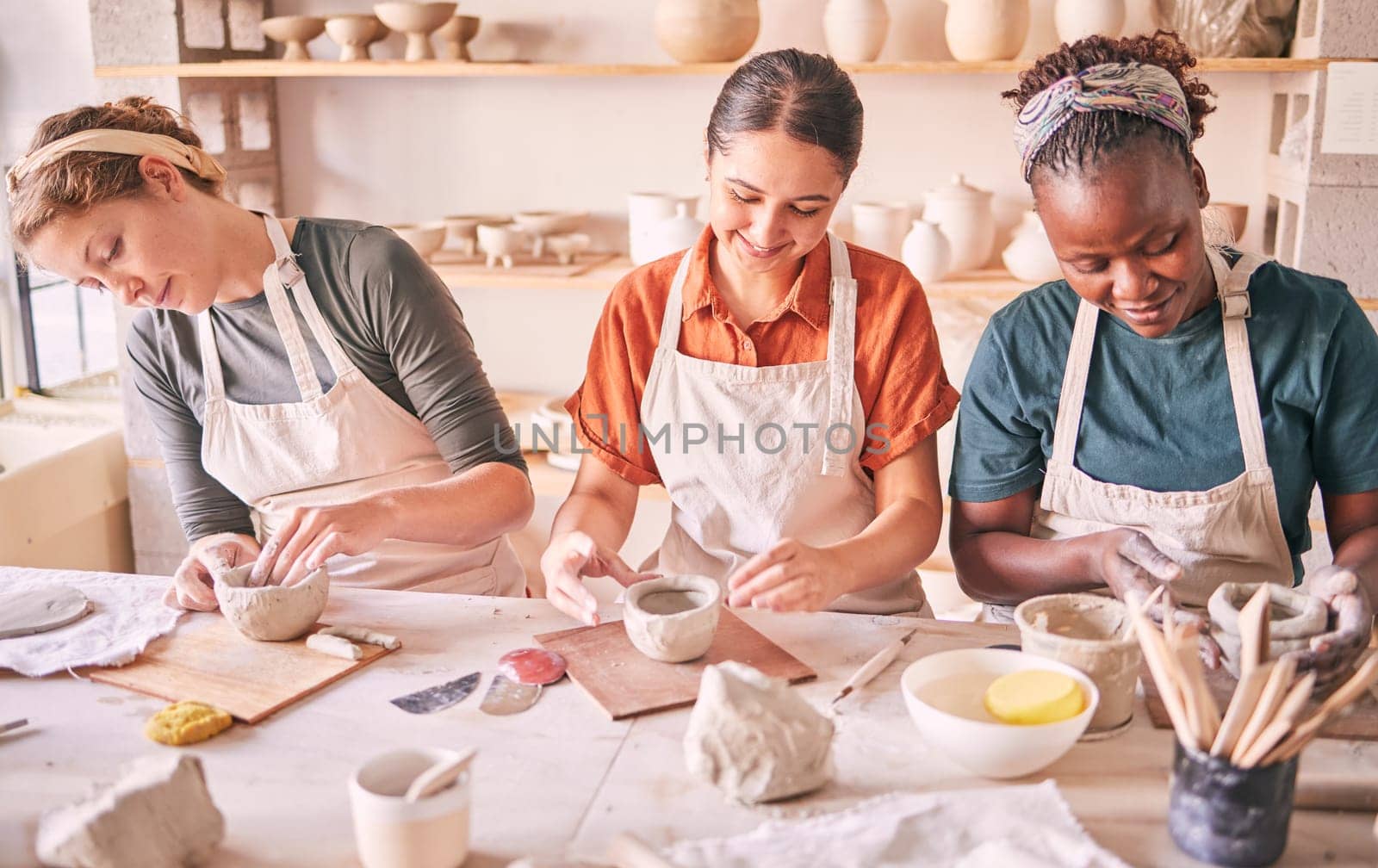 Pottery class, creative workshop or women design sculpture mold, clay manufacturing or art product. Diversity, ceramic retail store or startup small business owner, artist or studio group molding by YuriArcurs