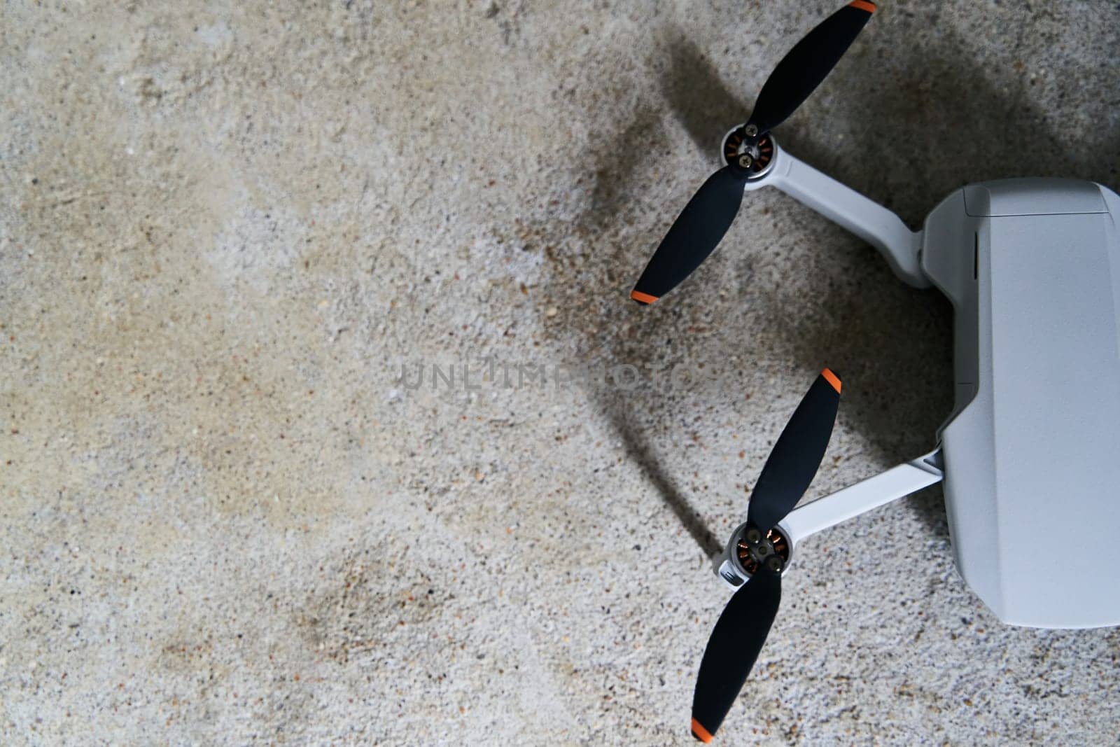 Small gray quadcopter on a gray background. Quadrocopter close-up. High quality photo