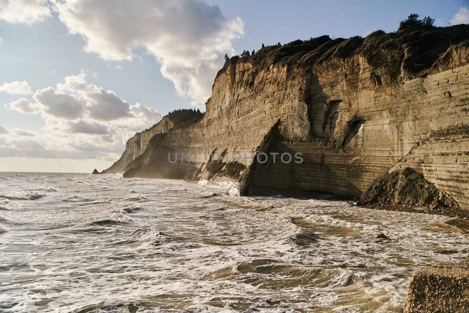View of Logas Beach and the amazing rocky cliff in Peroulades. Corfu island. Greece by driver-s
