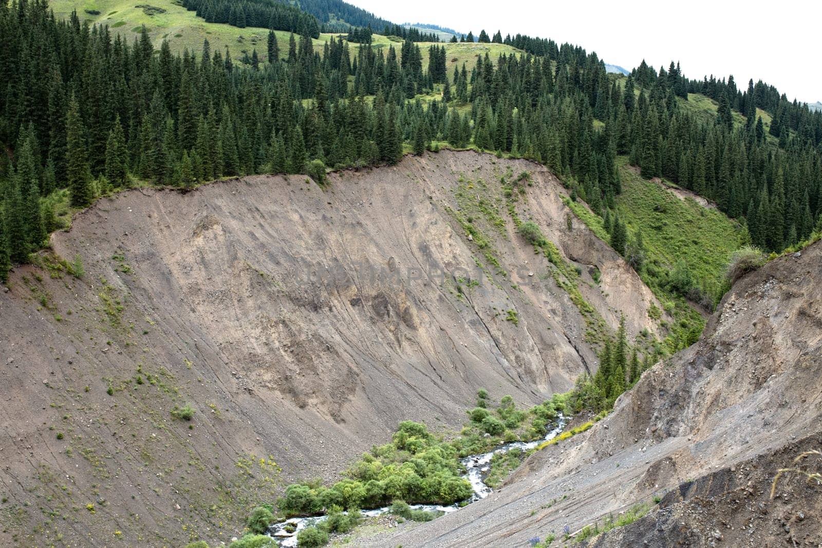 a mountain quarry with a river on a summer day.