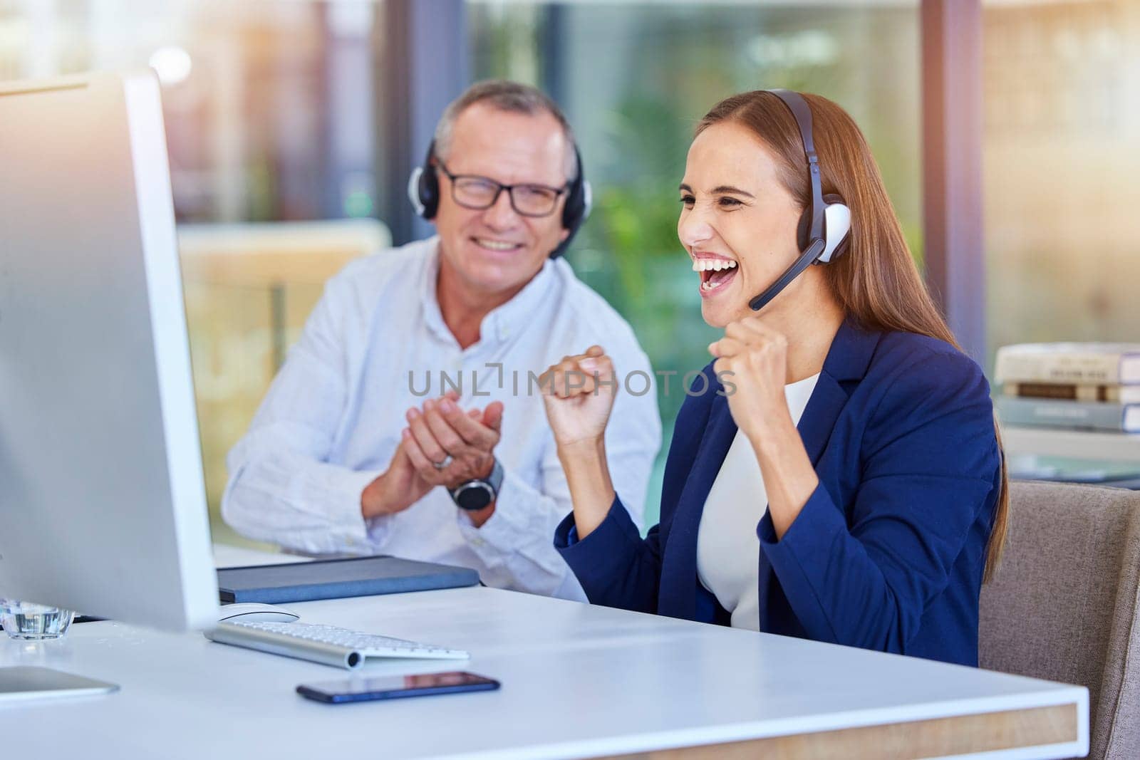 Teamwork, call center or success deal on computer for customer service, contact us support or CRM consulting. Celebration, consultation or communication for wow, winner smile or happy telemarketing by YuriArcurs