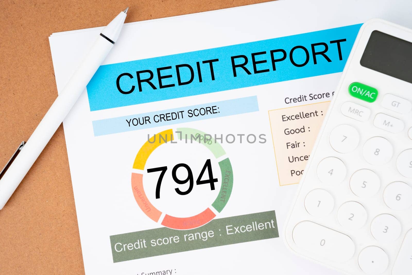 The Credit score report and calculator on the desk. by Gamjai