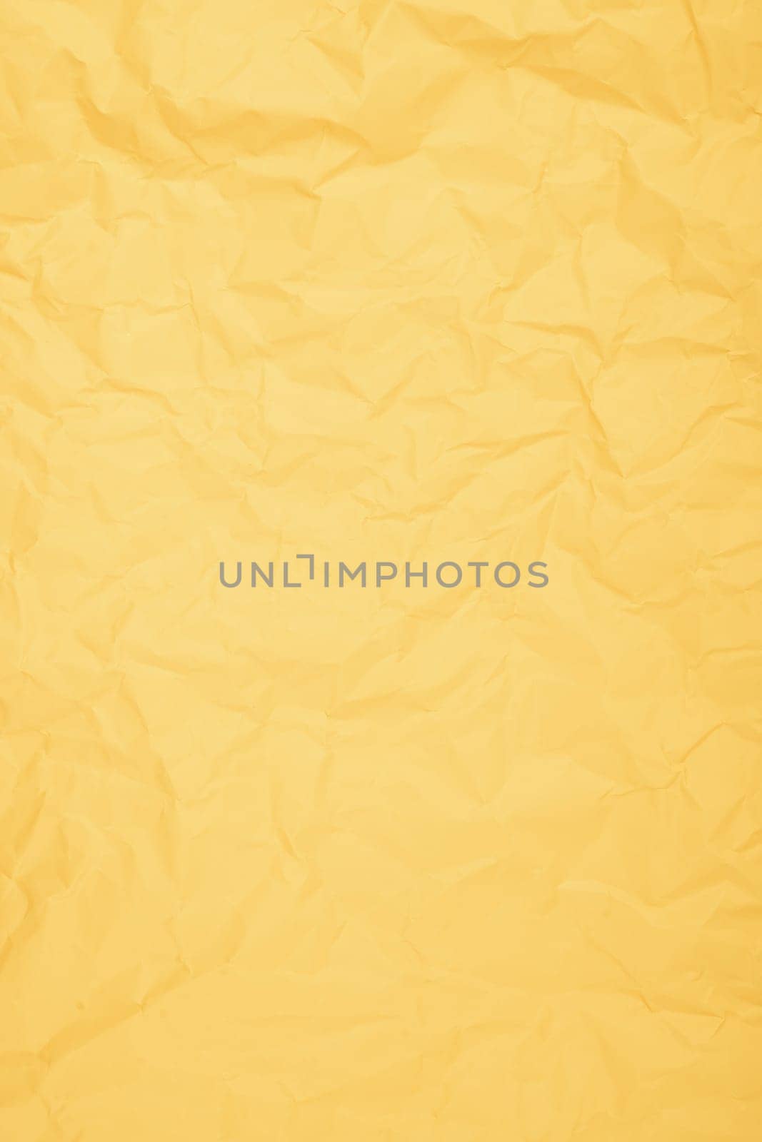 The Vertical yellow color creased paper background texture. by Gamjai