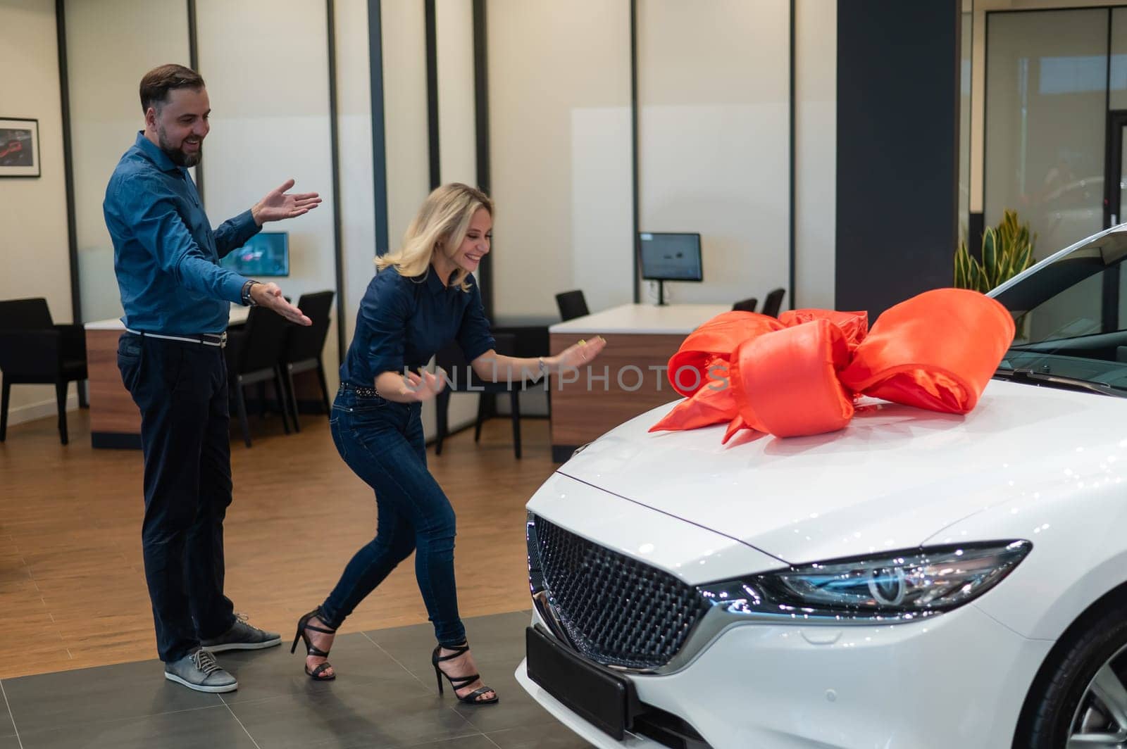 A bearded man makes a gift to his beloved wife in the form of a new white car. by mrwed54