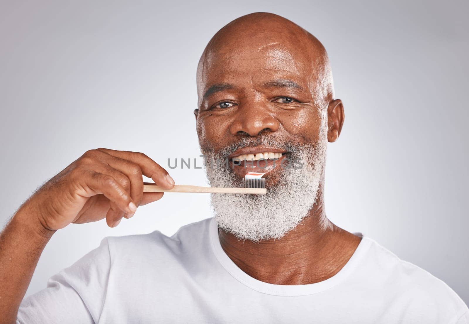 Portrait, black man and brushing teeth with toothbrush for dental wellness, healthy lifestyle or cleaning cosmetics in Nigeria. Happy male model, oral mouth care and mature smile on studio background.
